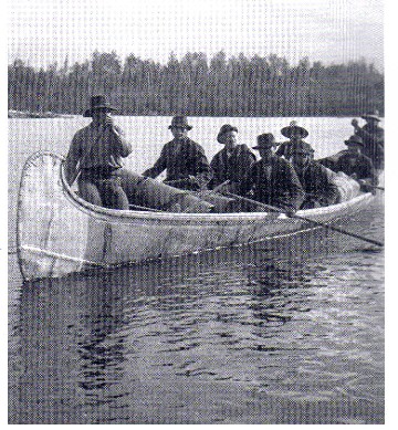 Large heavily laden fur-trade birch bark canoe arriving at Kipawa post on Grand Lake Victoria, Quebec, 1902 ; the bows are designed in the upright stem profile of the Algonquin of western Quebec. Rolls of birch bark for canoe building , seen in the front of the canoe , were a common trade item ; photo , Archives of Ontario