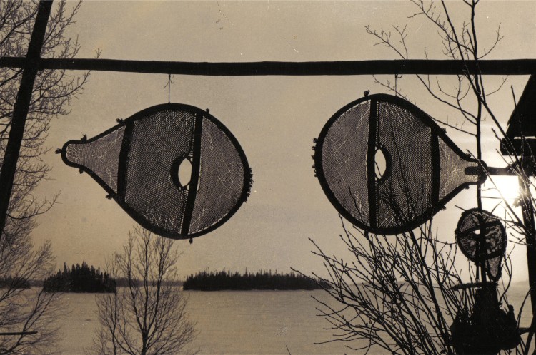 Newly made beavertail snowshoes hung to freeze -dry . The snowshoes are washed with soapy water and then freeze dried to whiten them for aesthetic reasons, Assinica Lake , 1980 ; photo Henri Vaillancourt 