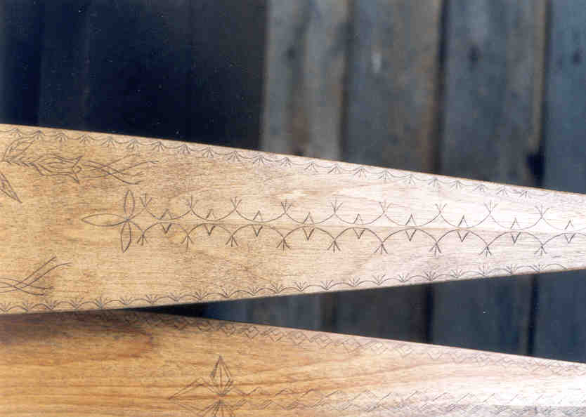 close-up of a section of canoe paddle blade decorated with traditional