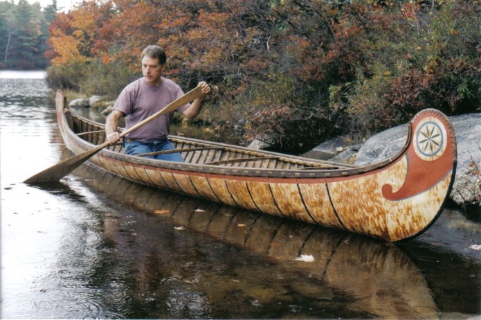 18 foot Fur-Trade style birch bark canoe  with typical painted  decoration and fancy root sewng on bows . This type  of bark canoe was built from the 1600's to the early 1900's  by both Indian and French craftsmen for Canadian government and military purposes ,as well as  for the fur-trade