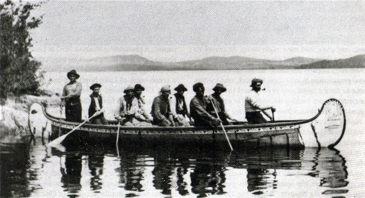 Elaborately  decorated fur-trade birchbark canoe on Lake Chibougamau in Quebec named the ROBROY ; the more highly finished canoes were often decorated with complex patterns such as the floral motif bordering the gunnels in this canoe, and given named after the fashion of European boats. 