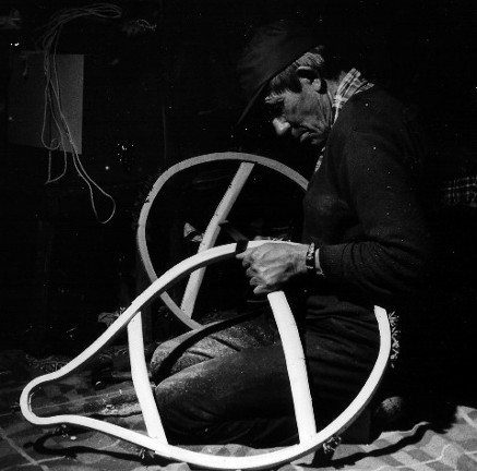Philip Bosum  smoothing the finished beavertail snowshoe frames with a flat file ; Assinica Lake, Quebec ; photo Henri Vaillancourt  1980 