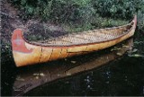  A 1/2 scale model of a 24' Fur-Trade type birch bark canoe . This style with an upright stem profile was formerly built by the Algonquin of western Quebec.