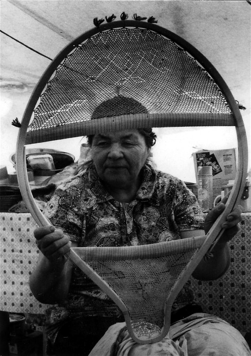 Mistassini Cree beavertail snowshoes laced with caribou skin and ornamented with the woven geometric designs once common in the eastern woodlands ; yarn tufts ornament the birch wood frame ; from the video ''Beavertail Snowshoes''; photo Henri Vaillancourt 1977